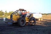 Skidder trying to pull stuck Chevy