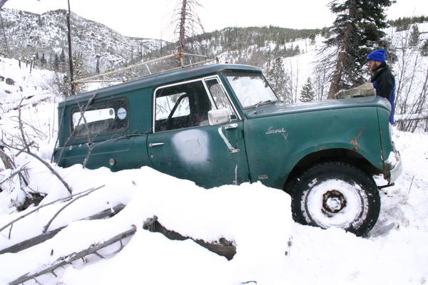 Stuck against a fallen tree, trying to go up a steep icy hill.