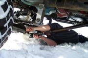 Loretta's front driveshaft came apart when Mike tried ot winch hte Jeep backwards -Bozeman Mountaineer Rob Currier puts it back 
