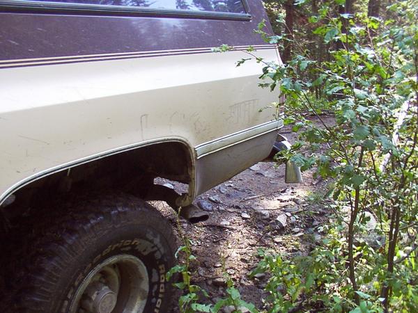 Doug hurts Patti's Suburban and loses a $4 bet in the process when he drops off a rock and peels the rear bumper.