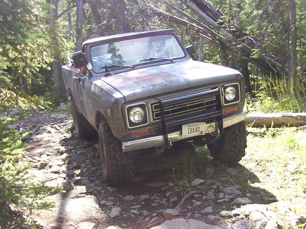 Tom drives over a fallen tree in the trail.