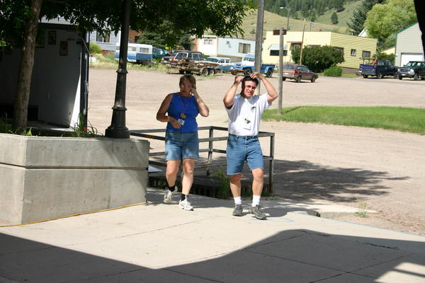 Frontier members Bryan and Joan Lewis walking up to help - Brian in mid "fix my hair after riding in the Jeep"