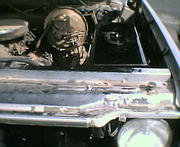 Just enough room to the side to allow use of the latches, and enough room to the back to clear the hood spring.