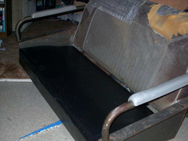 Newly covered seat bottom, no stitching involved, just folding and stapling, like wrapping a giant present.