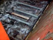 A couple pieces of steel for added support, placed over ridges in the floor, held down with resin. 1st layer of fiberglass. piec