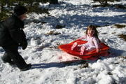Sam Burton pulls Joleigh Mandera on the sled